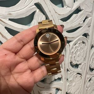 Movado rose gold watch with diamond in the middle